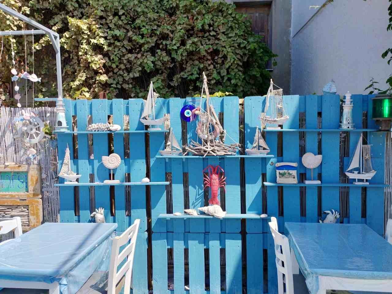 Blue chairs and decoration at a Plomari taverna